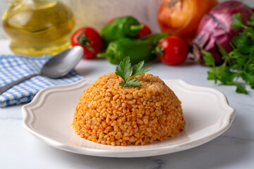 Traditional turkish bulgur pilaf with tomato sause in plate (Turkish name; meyhane pilavi)