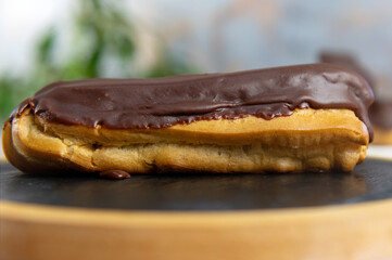French ecler with chocolate. Traditional french dessert eclair.