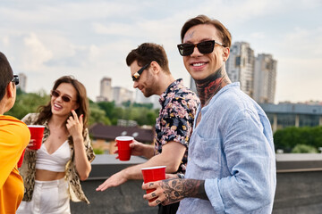 attractive jolly friends with sunglasses in casual attires having fun at rooftop party together