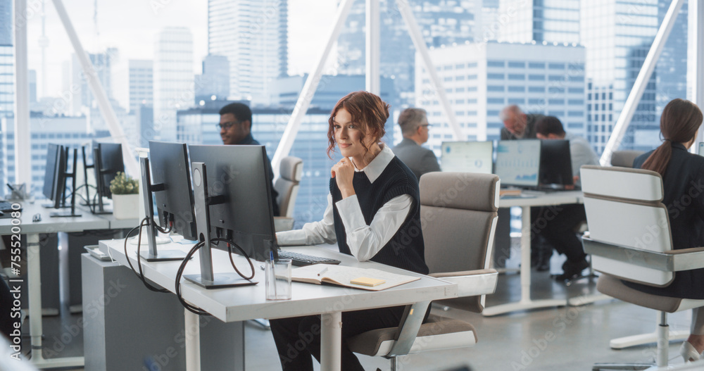 Poster Young Female Data Scientist Typing On Desktop Computer In Bright And Diverse Corporate Office With Megapolis Window View. Professional Caucasian Woman Working In Tech Startup Company With Colleagues.