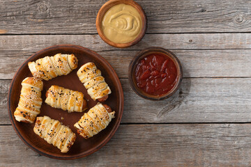 Homemade Sausage in dough rolls on plate