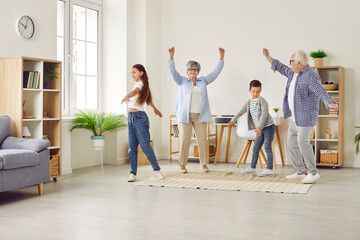 Happy, cheerful family playing and having fun together. Funny grandparents and children having a...