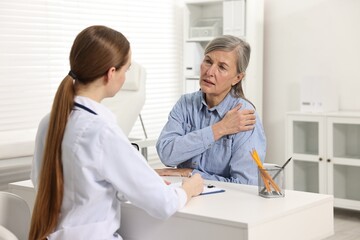 Arthritis symptoms. Doctor consulting patient with shoulder pain in hospital