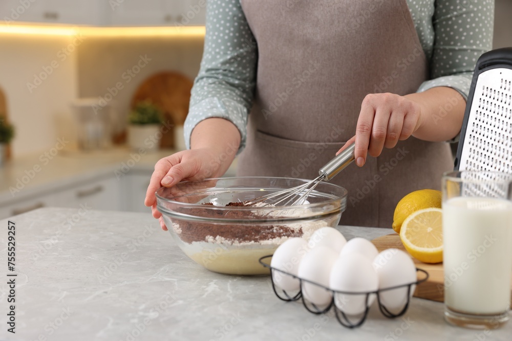 Wall mural woman making chocolate dough with whisk in bowl at gray marble table, closeup