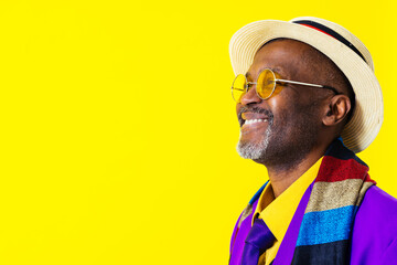 Cool senior black man with fashionable outfit portrait - African old person wearing cool stylish clothing on colorful background