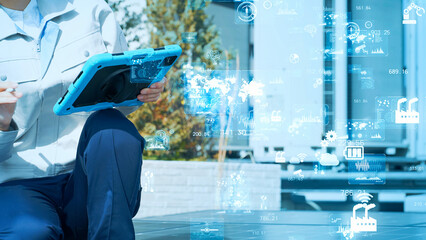 Workers inspecting equipment and digital data. Industrial technology. IIoT. Industrial Internet of Things.