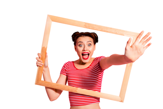 Portrait of her she nice cute charming attractive funny funky cheerful cheery girl in striped t-shirt holding in hands wooden frame opened mouth giving hand isolated on pink pastel background
