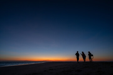 Fototapeta na wymiar People at sunnset on a sandbar in Gulf of Carpentari