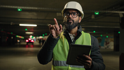 Foreman inspecting parking lot underground urban industrial heavy industry engineer Arabian man...
