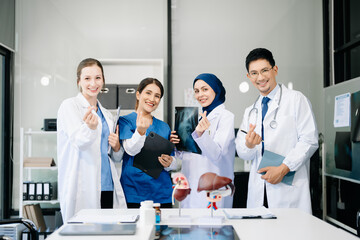 Fototapeta premium Successful team of medical doctors looking at camera and smiling while standin. Health, professional and people team in hospital