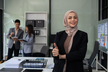 Happy  female businessman giving a thumbs up gesture of approval and success.