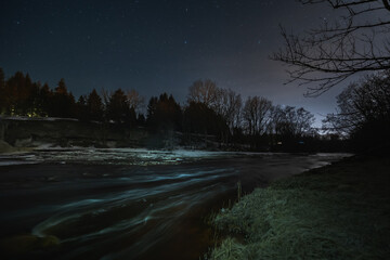 Fast-flowing Jagala river in early spring, night scene of Estonian nature.