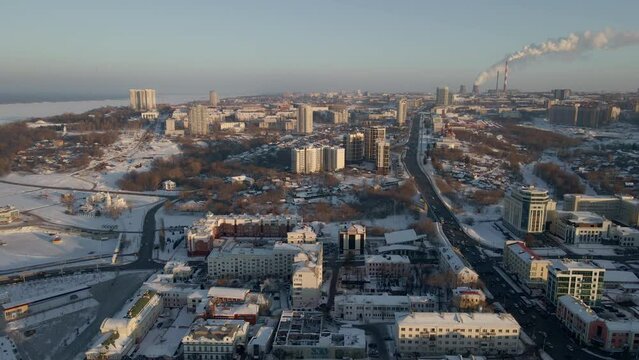 Aerial view of the city of Cheboksary, Russia 2021. Landscape of the city of Cheboksary. Colorful winter sunset scene with pink purple sky. Sunset cityscape 4K