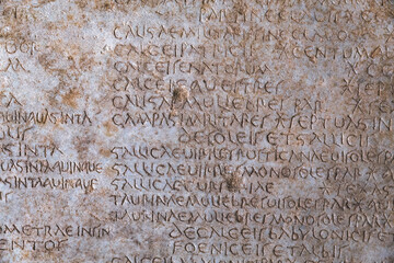 Ancient Roman script on stone, text of Diocletian's edict detailing prices in Latin language, historical artifact from 4th century. Retro text background. Kusadasi, Turkiye (Turkey)