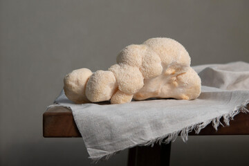 Big Lion's Maine raw mushroom on wooden table. 