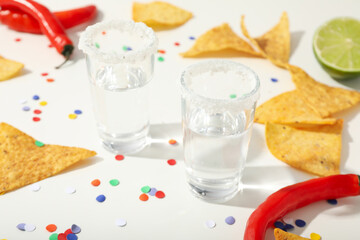 Nachos with tequila and lime on a white background