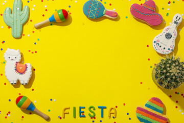 The inscription "Fiesta" with festive decorations on a yellow background