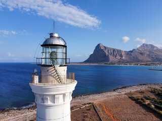 Fototapeta na wymiar the coast of San Vito Lo Capo with the white lighthouse tower in the foreground