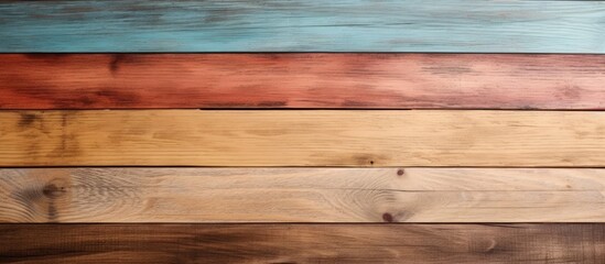 This close-up view shows a multicolored wooden wall made of new planks of oak parquet with a rustic texture. The colors vary, creating a vibrant and unique visual effect.