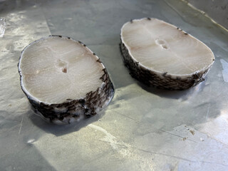 fresh raw cold seafood cod whole fish ikan on white ice background halal food cuisine hyper market...