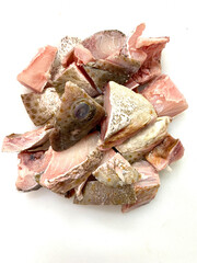 fresh raw cold seafood grouper cut whole fish ikan on white ice background halal food cuisine hyper...