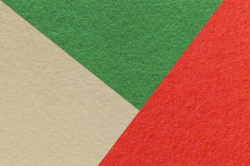 Texture of craft red, green and beige shade color paper background, macro. Vintage abstract cardboard
