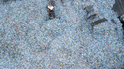 Aerial view plenty of plastic bottles, Waste plastic bottles other types of plastic waste at the waste disposal site, plastic bottles at the factory for processing and recycling PET recycling plant.