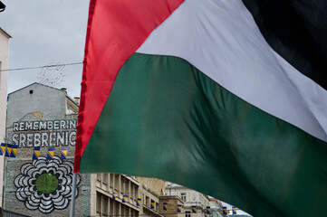 Palestine Flags with the drawing of Remember Srebrenica on the wall. Free Palestine.