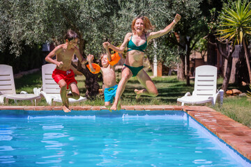 Family about to joyfully leap into backyard pool - 755574658