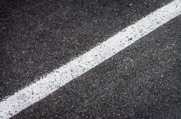 white streak of paint on gray asphalt