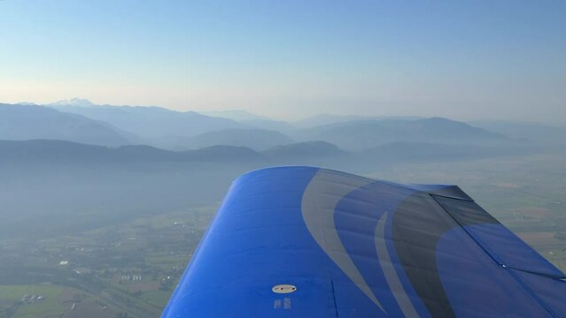 View of Wing of Light Airplane In Flight Producing Lift