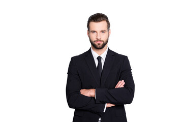 Portrait of attractive, brunet, concentrated, stylish, virile, harsh, trendy business person with modern hairstyle in black suit with tie having his arms crossed, isolated on grey background