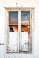 Old closed wooden window with broken glass