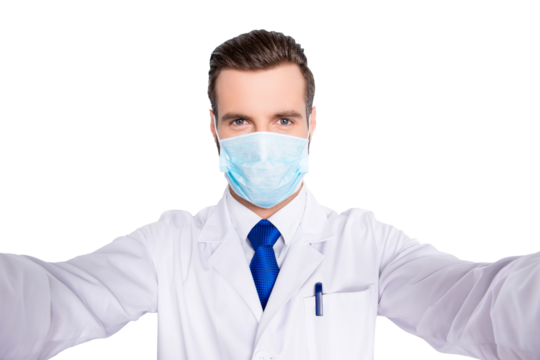 Self portrait of creative funny dentist in white lab coat, blue, tie, protective face mask shooting selfie on smart phone, having rest relax video call, isolated on grey background