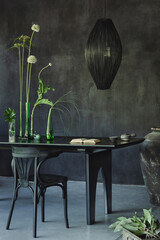 Minimalist composition of japandi dining room interior with black table, glass vase with green...