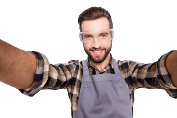 Self portrait of cheerful attractive man with stubble shooting selfie with two hands on front camera of smart phone during break, pause, time out, having res relax, isolated over grey background