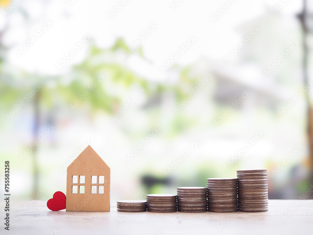 Wall mural miniature house and stack of coins. the concept of saving money for house, property investment, hous