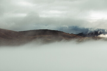 Misty Mountain Tops Amidst Clouds