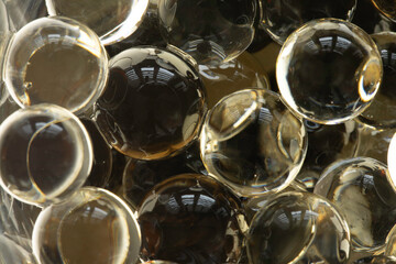 Scented gel beads (hydrogel) in close-up, light reflections. Background.