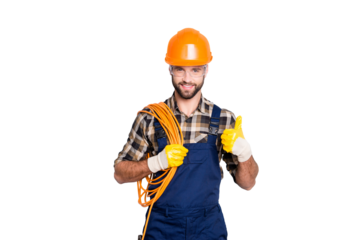 Portrait of handsome joyful electrician in hardhat, overall, shirt with bristle, holding rolled wires on shoulder, showing thumb up recommend approve sign over grey background