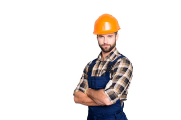 Portrait with copyspace of attractive handsome repairer in shirt and overall looking at camera isolated on grey background, having arms crossed, isolated on grey background