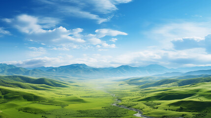 Paysage d'une prairie avec de l'herbe verte, des montagnes en arrière-plan et un beau ciel bleu avec nuages. Fond d'écran, décor, paysage calme. Pour conception et création graphique. - obrazy, fototapety, plakaty