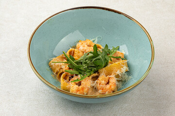 Portion of italian pappardelle pasta with shrimp