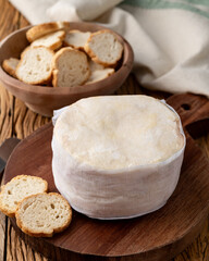 Jordao cheese, brazilian country cream cheese with toasts over wooden table