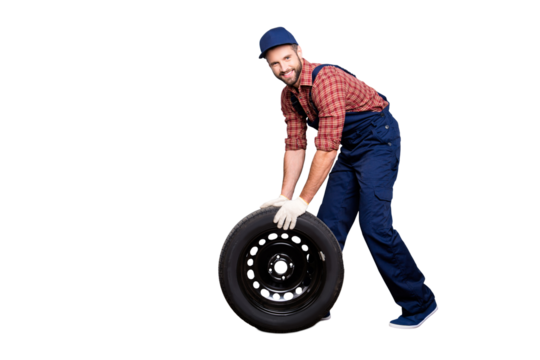 Full size body portrait with copy space of joyful attractive mechanic with stubble in blue overall, shirt, cap trundle tire looking at camera, isolated on grey background - Powered by Adobe
