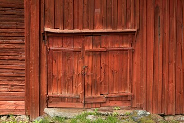 Old weathered barn door on an old traditional wooden barn, Finland.