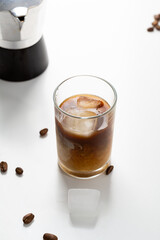 Iced coffee in glass on light surface cold beverage