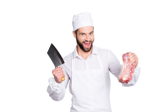 Portrait of crazy funny butcher with stubble having cleaver and fresh meat in arms, shouting, screaming with open mouth, isolated on grey background
