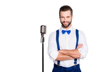 Portrait of famous joyful singer with bristle, wearing blue pants bowtie suspenders shirt, having...