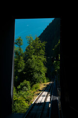 Railroad Track in the Forest on Mountain Side and Lake Lucerne in a Sunny Day in Burgenstock, Nidwalden in Switzerland.